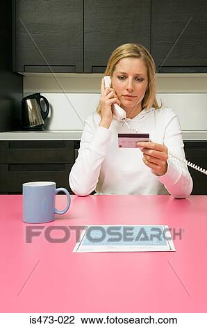 Stock Image - Woman telephone banking. Fotosearch
