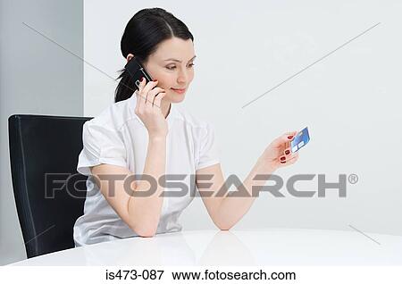 Stock Photo - Woman telephone banking. Fotosearch