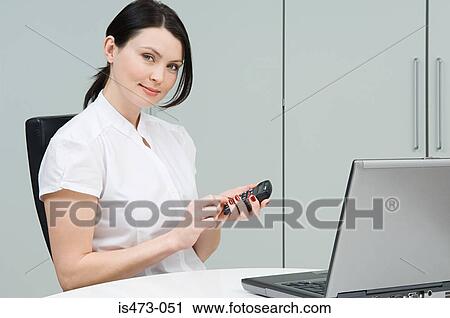 Woman using calculator View Large Photo Image Stock Image - Woman using calculator. Fotosearch