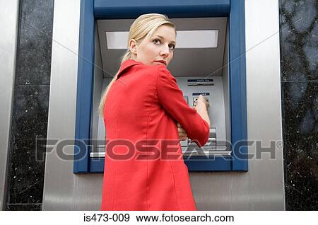 Woman using cash machine View Large Photo Image Stock Photo - Woman using cash machine. Fotosearch