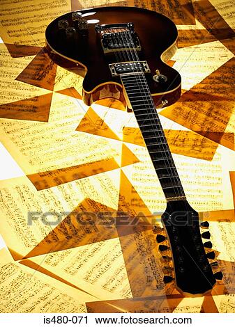 Electric guitar on sheet music View Large Photo Image Stock Image - Electric guitar on sheet music. Fotosearch