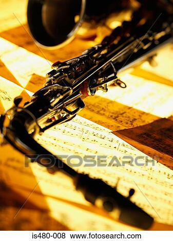 Saxophone and sheet music View Large Photo Image Stock Photo - Saxophone and sheet music. Fotosearch