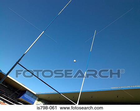 Rugby ball over a rugby post View Large Photo Image Stock Image - Rugby ball over a rugby post. Fotosearch