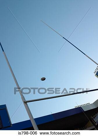 Rugby ball over a rugby post View Large Photo Image Stock Photograph - Rugby ball over a rugby post. Fotosearch