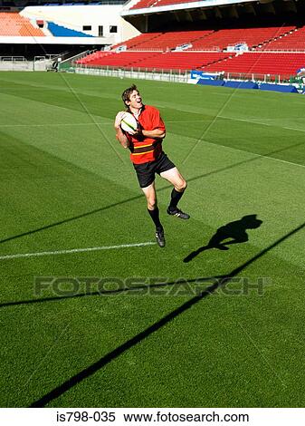 Stock Photography - Rugby player catching ball. Fotosearch