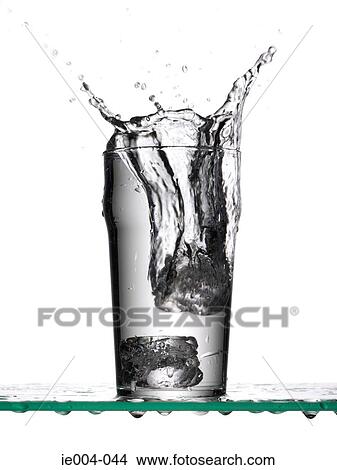 Ice cubes dropping into glass of water View Large Photo Image Picture - Ice cubes dropping into glass of water. Fotosearch