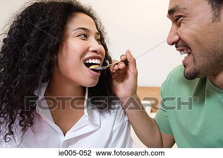 A husband feeding his wife View Large Photo Image Stock Image - A husband feeding his wife. Fotosearch