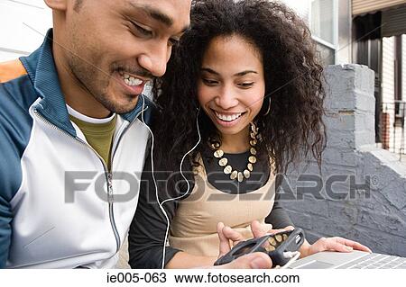 Couple listening to music View Large Photo Image Stock Image - Couple listening to music. Fotosearch