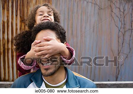 Daughter covering fathers eyes View Large Photo Image Stock Image - Daughter covering fathers eyes. Fotosearch