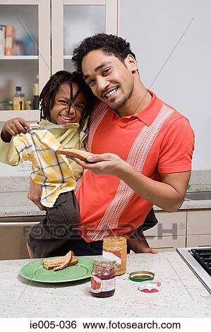 Stock Photograph - Father and son in the kitchen. Fotosearch
