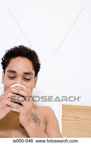 Young man drinking tea View Large Photo Image Stock Photograph - Young man drinking tea. Fotosearch