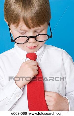 Boy adjusting tie View Large Photo Image Stock Photograph - Boy adjusting tie. Fotosearch