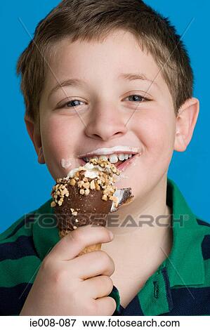 Boy eating an ice cream View Large Photo Image Stock Photo - Boy eating an ice cream. Fotosearch