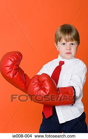 Boy wearing boxing gloves View Large Photo Image Picture - Boy wearing boxing gloves. Fotosearch