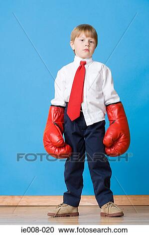 Boy wearing boxing gloves View Large Photo Image Stock Image - Boy wearing boxing gloves. Fotosearch