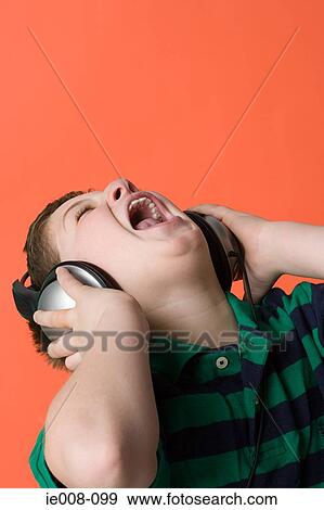 Boy wearing headphones and singing View Large Photo Image Stock Photo - Boy wearing headphones and singing. Fotosearch
