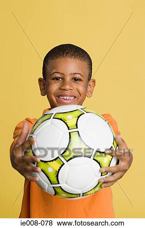 Boy with a football View Large Photo Image Stock Photo - Boy with a football. Fotosearch