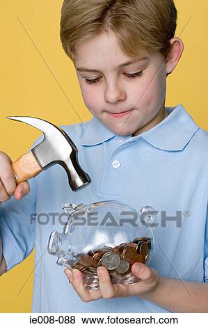 Boy with hammer and piggy bank View Large Photo Image Stock Photo - Boy with hammer and piggy bank. Fotosearch