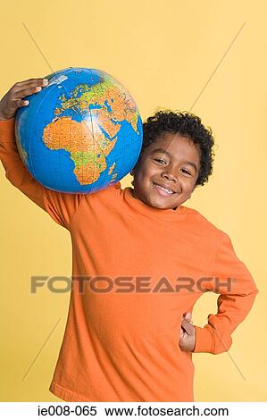 Boy with inflatable globe View Large Photo Image Stock Photography - Boy with inflatable globe. Fotosearch