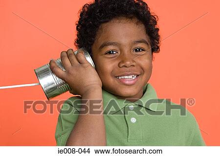 Boy with tin can telephone View Large Photo Image Picture - Boy with tin can telephone. Fotosearch