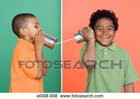 Boys using tin can telephone View Large Photo Image Stock Photo - Boys using tin can telephone. Fotosearch