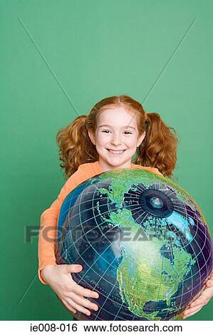 Girl holding a globe View Large Photo Image Stock Photograph - Girl holding a globe. Fotosearch