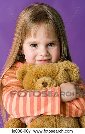 Girl hugging teddy bear View Large Photo Image Stock Photo - Girl hugging teddy bear. Fotosearch