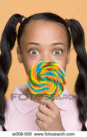 Girl with a lollipop View Large Photo Image Stock Photo - Girl with a lollipop. Fotosearch