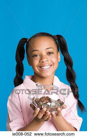 Girl with a piggy bank View Large Photo Image Stock Image - Girl with a piggy bank. Fotosearch