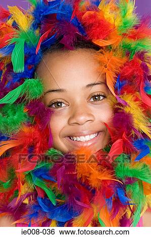 Stock Photograph - Girl with feathers around her face. Fotosearch