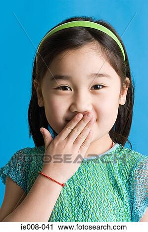Girl with hand over her mouth View Large Photo Image Stock Image - Girl with hand over her mouth. Fotosearch