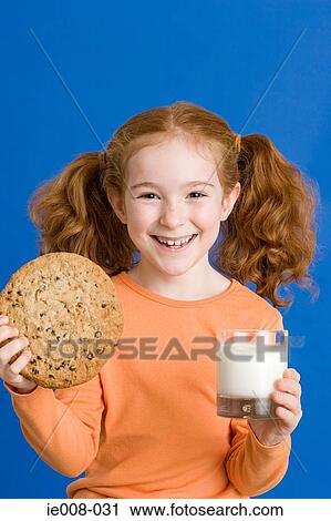 Girl with milk and cookie View Large Photo Image Stock Image - Girl with milk and cookie. Fotosearch