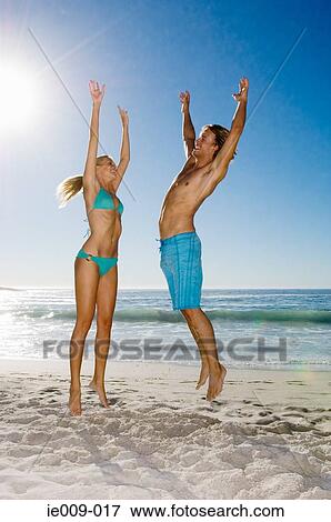 Stock Photo - Couple jumping. Fotosearch