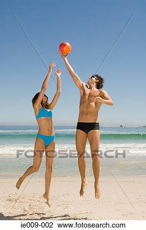 Couple playing volleyball View Large Photo Image Stock Image - Couple playing volleyball. Fotosearch