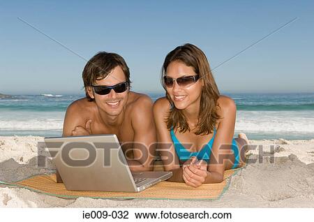 Couple using laptop View Large Photo Image Stock Image - Couple using laptop. Fotosearch