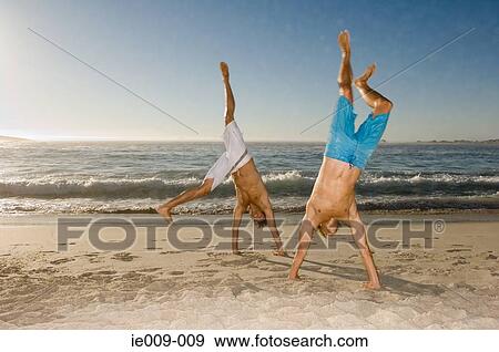 Young men doing cartwheels View Large Photo Image Stock Photo - Young men doing cartwheels. Fotosearch