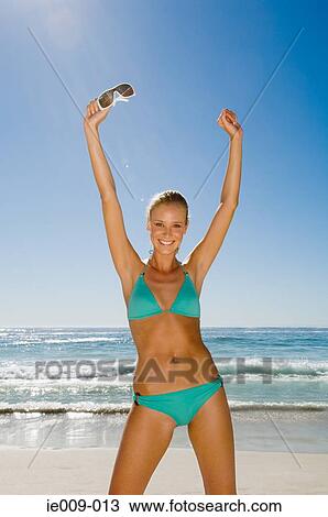 Stock Image - Young woman stretching. Fotosearch
