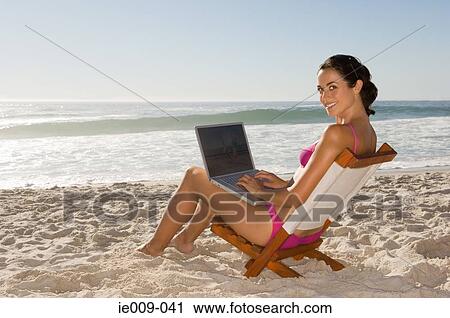 Young woman using laptop View Large Photo Image Stock Image - Young woman using laptop. Fotosearch