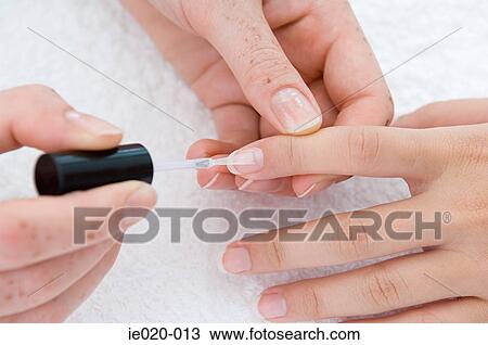 Stock Image - Woman applying nail varnish. Fotosearch