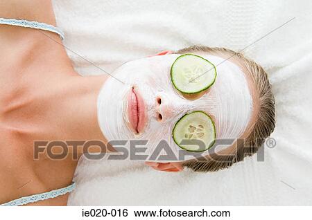 Stock Photograph - Woman wearing a face mask. Fotosearch