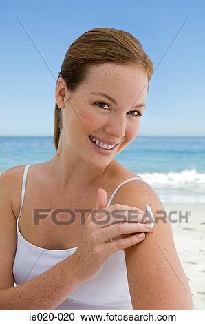 Young woman applying suncream View Large Photo Image Stock Image - Young woman applying suncream. Fotosearch