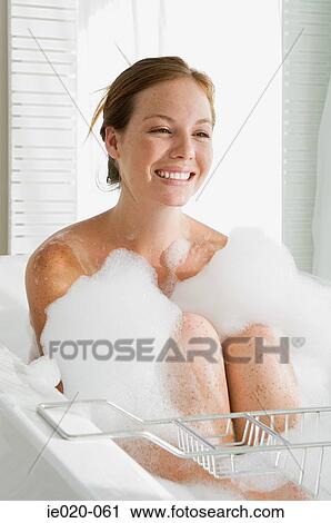 Young woman having a bubble bath View Large Photo Image Stock Image - Young woman having a bubble bath. Fotosearch