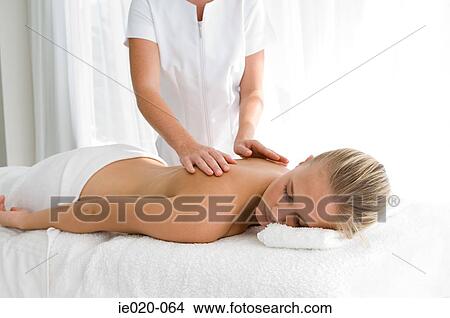 Young woman having back massaged View Large Photo Image Picture - Young woman having back massaged. Fotosearch