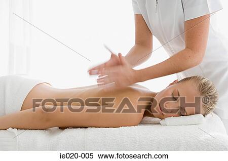 Young woman having back massaged View Large Photo Image Stock Photography - Young woman having back massaged. Fotosearch