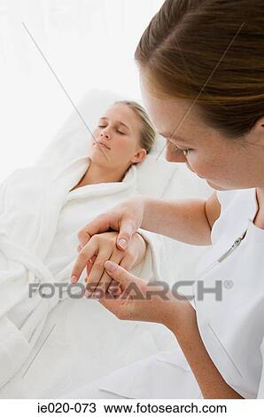 Young woman having hand massaged View Large Photo Image Stock Image - Young woman having hand massaged . Fotosearch