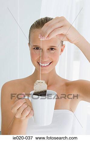 Young woman holding tea bag View Large Photo Image Stock Photo - Young woman holding tea bag. Fotosearch