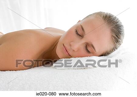 Stock Image - Young woman lying on front. Fotosearch
