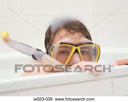 Stock Photo - Girl wearing snorkel in bath. Fotosearch