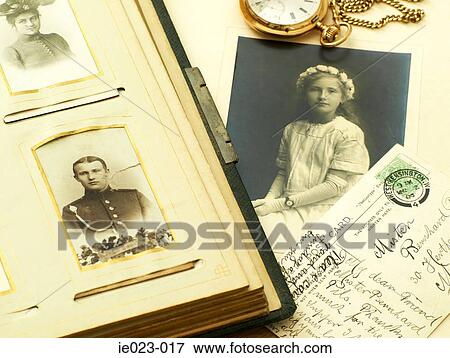 Stock Photo - Photographs with postcard and pocket watch. Fotosearch