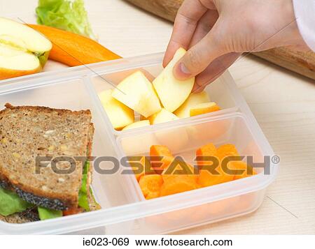 Preparing a packed lunch View Large Photo Image Stock Photo - Preparing a packed lunch. Fotosearch